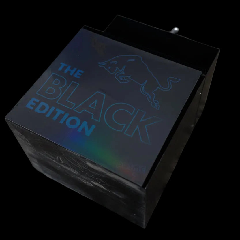 Black product packaging with 'The Black Edition' text on a dark textured surface